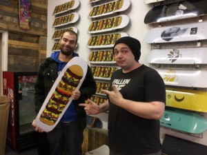 Winning artist Max Whetter (left) with Tom Hudson of Roots Skate Shop, Camborne in Cornwall